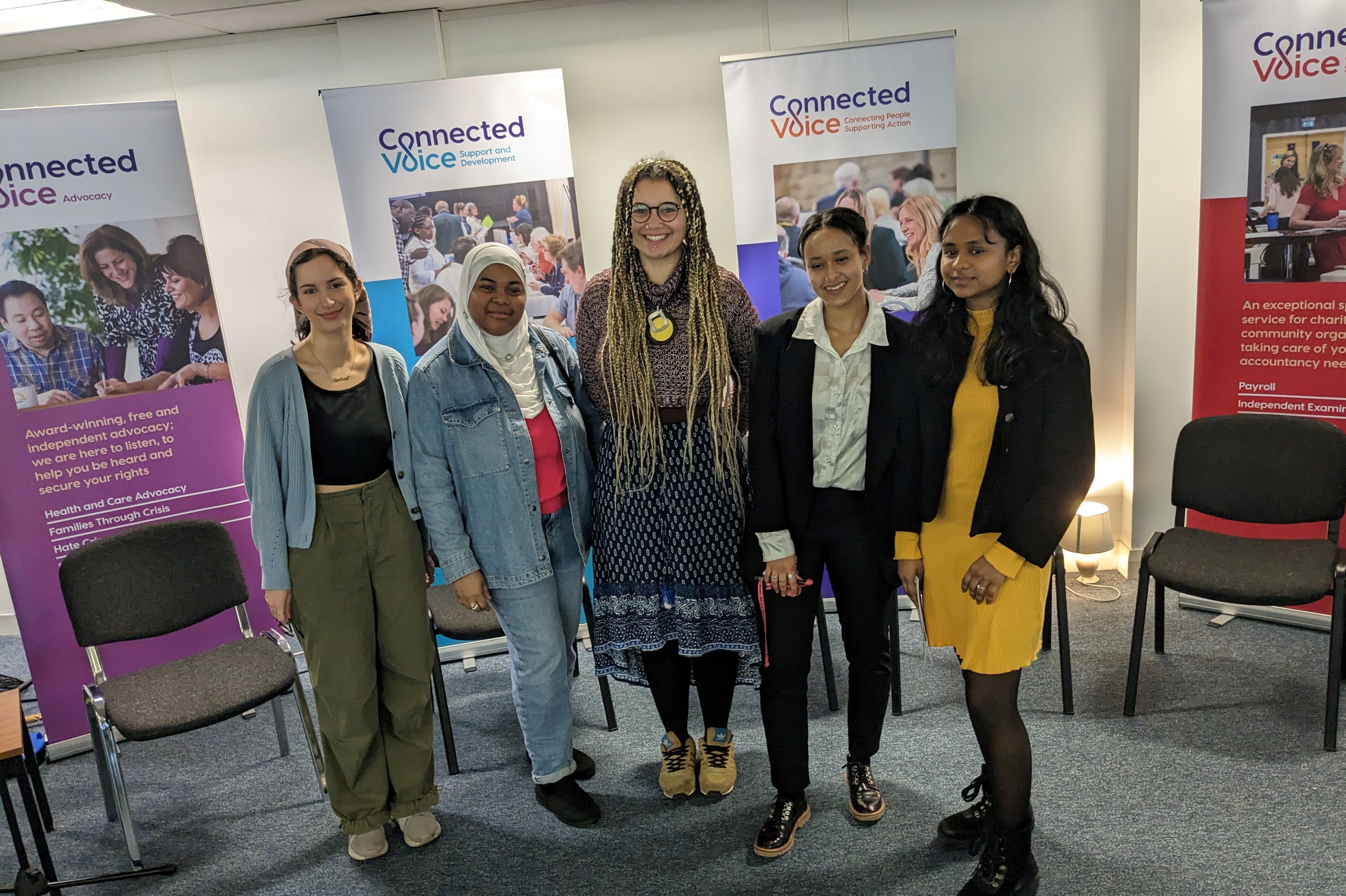 A group of women standing together smiling