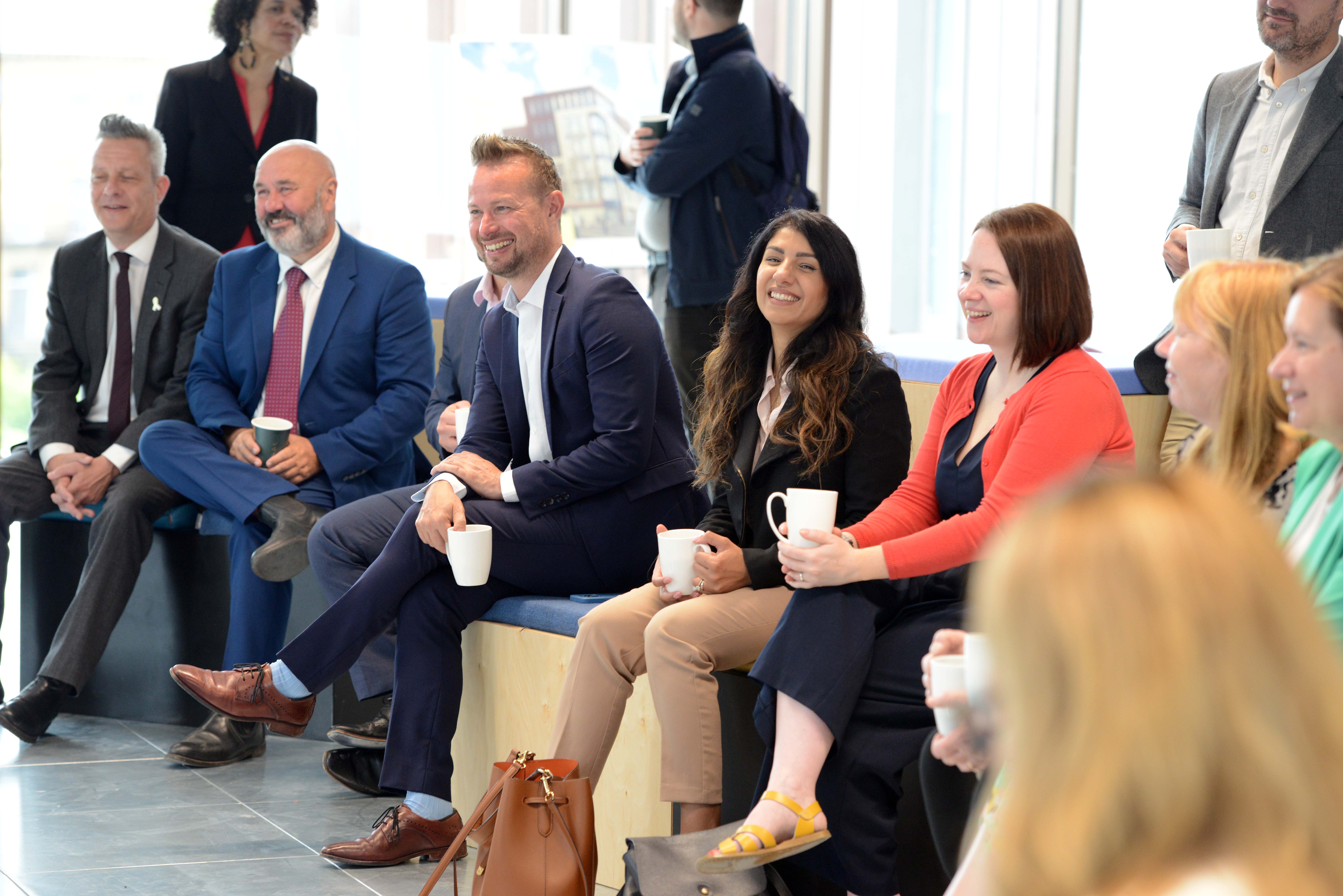 Connected Voice Chief Executive Lisa Goodwin sits among a small gathering of people for the opening ceremony